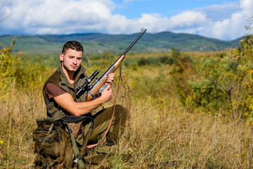 Hunting hobby and leisure. Man charging hunting rifle. Hunting equipment concept. Hunter khaki...