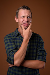 Studio shot of man against brown background