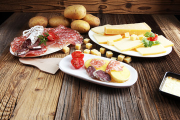 Delicious traditional Swiss melted raclette cheese on diced boiled or baked potato.