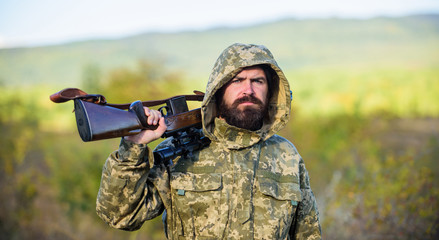 Bearded hunter rifle nature background. Hunting big game typically requires tag each animal...