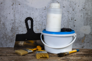  Paint can and brush on the table.