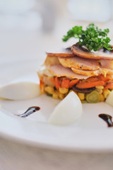 dish with mushrooms ham carrots and corn with eggs close-up