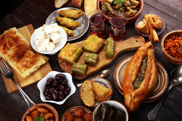 Middle eastern or arabic dishes and assorted meze, concrete rustic background. sambusak. Turkish Dessert Baklava with pistachio. Sarma. Halal food. Lebanese
