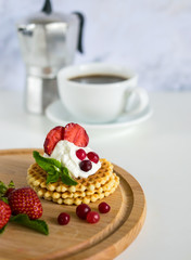 Waffles with whipped cream and strawberries