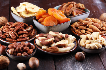 dried fruits and assorted nuts composition on rustic table