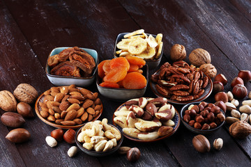 dried fruits and assorted nuts composition on rustic table