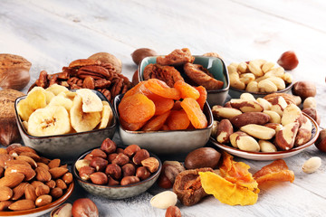 dried fruits and assorted nuts composition on rustic table