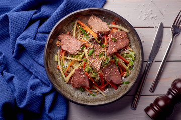 Asian salad with greens, vegetables and sprouts and meat