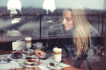 Nice female in cafe eating cake