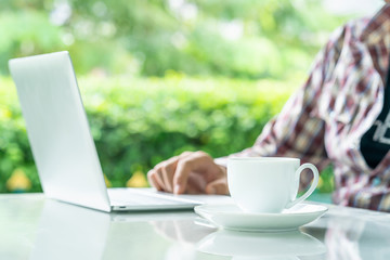 Fototapeta premium Laptop computer and cup of coffee on the table
