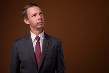 Studio shot of businessman against brown background