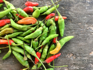Chilli Padi, Bird's Eye Chilli or Thai pepper on dark bown wooden.
