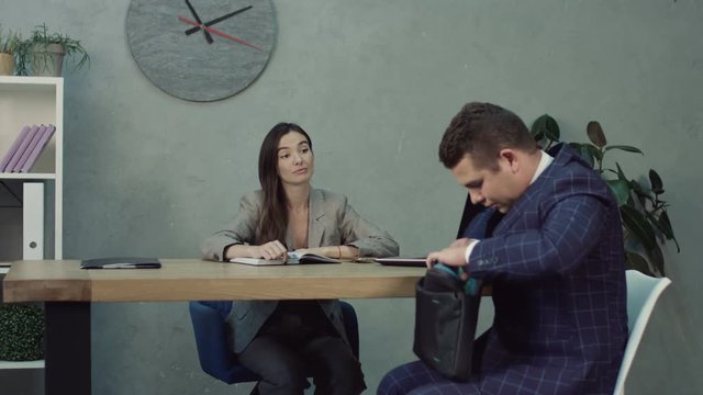 Nervous Stressed Job Seeker Searching For Application Form In Bag As He Arrived At Job Interview In Hr Office. Anxious Job Applicant Feeling Nervous In Human Resource Department During Interview.