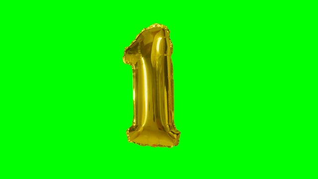 Number 1 one year birthday anniversary gold balloon floating on green screen