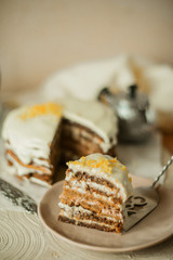 A piece of homemade carrot cake on a light background.