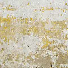 Abandoned grunge stucco wall. Peeling paint on wall