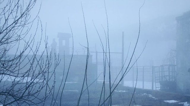 Soviet soldier in the guard tower. Winter scene. 
The clip can illustrate Persecution of Christians in the Eastern Bloc.