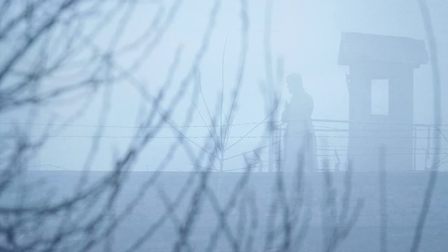 Soviet soldier in the guard tower. Winter scene. 
The clip can illustrate Persecution of Christians in the Eastern Bloc.