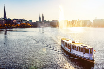 historic steam boat on Alster Lake in Hamburg, Germany in golden sunlight © Christian Horz