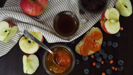 Delicious jam for tea and fresh fruit on the table.