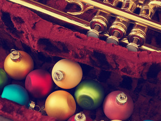 Colorful Christmas baubles with an old trumpet
