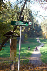 Vilnius, Lithuania,13 oct,2018: Direction sign in Antakalnis area to Sapiegos park and forest in Vilnius, Lithuania with people walking in the background. People relaxing in Sapiegos park,Vilnius