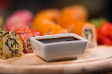 Bowl of soy sauce on a sushi board