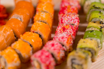 Colorful assortment of sushi rolls on a board