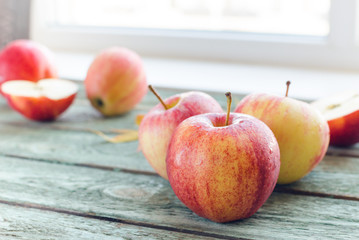 Red apples on turquoise wooden background. Autumn days.