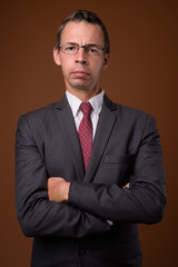 Studio shot of businessman against brown background