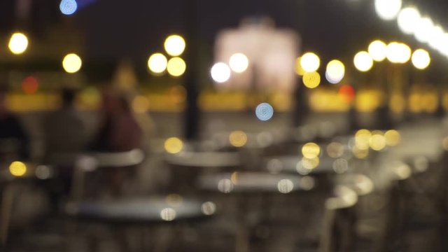 Bokeh lights on out of focus outdoor cafe