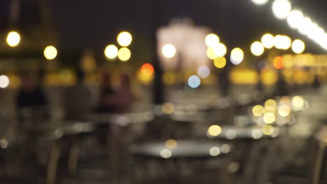 Out of focus background plate of city lights and outdoor restaurant