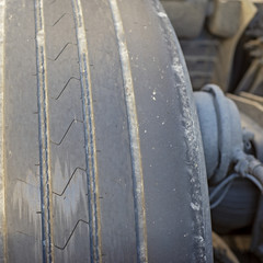 Worn out tire of heavy vehicle. Close up view - 227945483