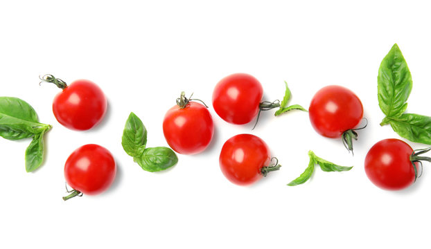 Fresh green basil leaves and cherry tomatoes on white background, top view