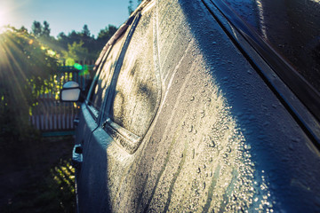 Dew drops on a gray car