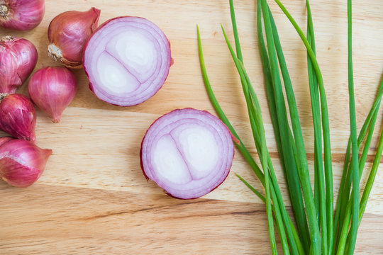 Slice shallot on wooden background, top view image shallot, green onion on wooden,