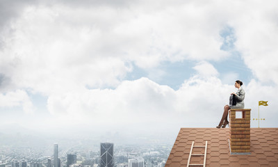 Businesswoman or accountant on house roof floating high above mo