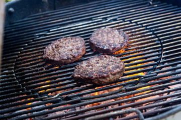 Hamburgers are cooking on the grill