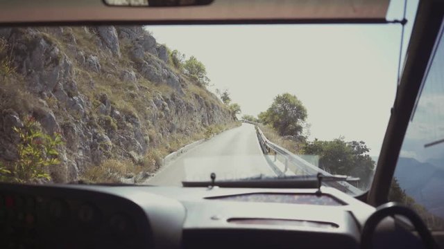 POV bus driving on mountain pass