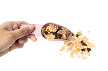 whole grain cereal flakes which mixed berry fruit and raisins for breakfast isolaed on white background