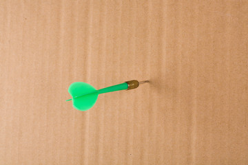 Green darts on yellow cardboard