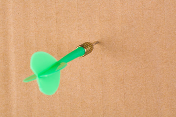 Green darts on yellow cardboard