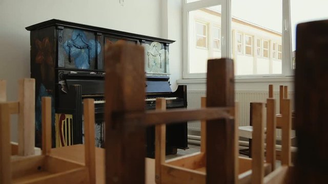 An Old piano in the empty classroom at School.