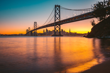 San Francisco skyline with Oakland Bay Bridge at sunset, California, USA