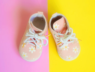 Baby pink shoes on a bright background