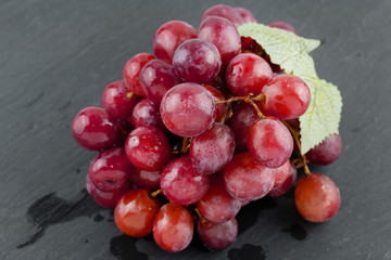 Ripe red grape on the dark background
