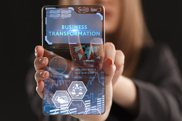 The concept of business, technology, the Internet and the network. A young entrepreneur working on a virtual screen of the future and sees the inscription: Business transformation