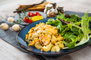 Cooked pasta with peeled shrimp, coconut milk sauce and broccoli