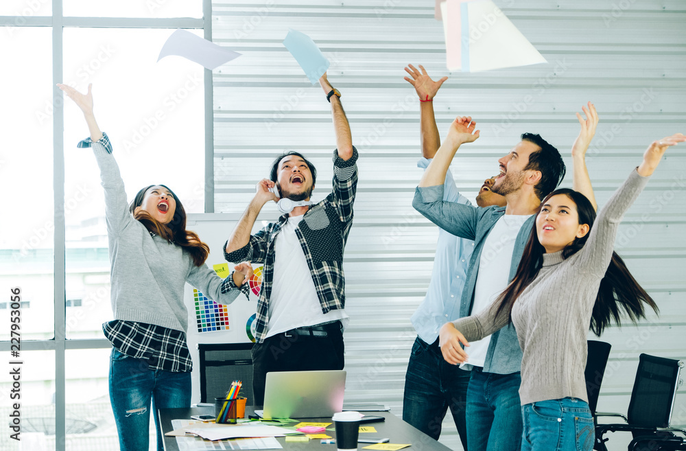 Poster diversity designer in casual cloth throw paper up in the air for success project at meeting table in