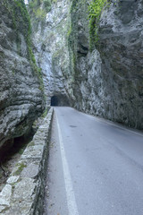 Fototapeta na wymiar road under steep ravine at Brasa gorge, Tremosine, Italy